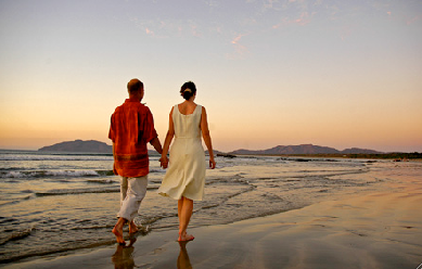 Couple walking on the beach enjoying the tranquil life in Costa Rica